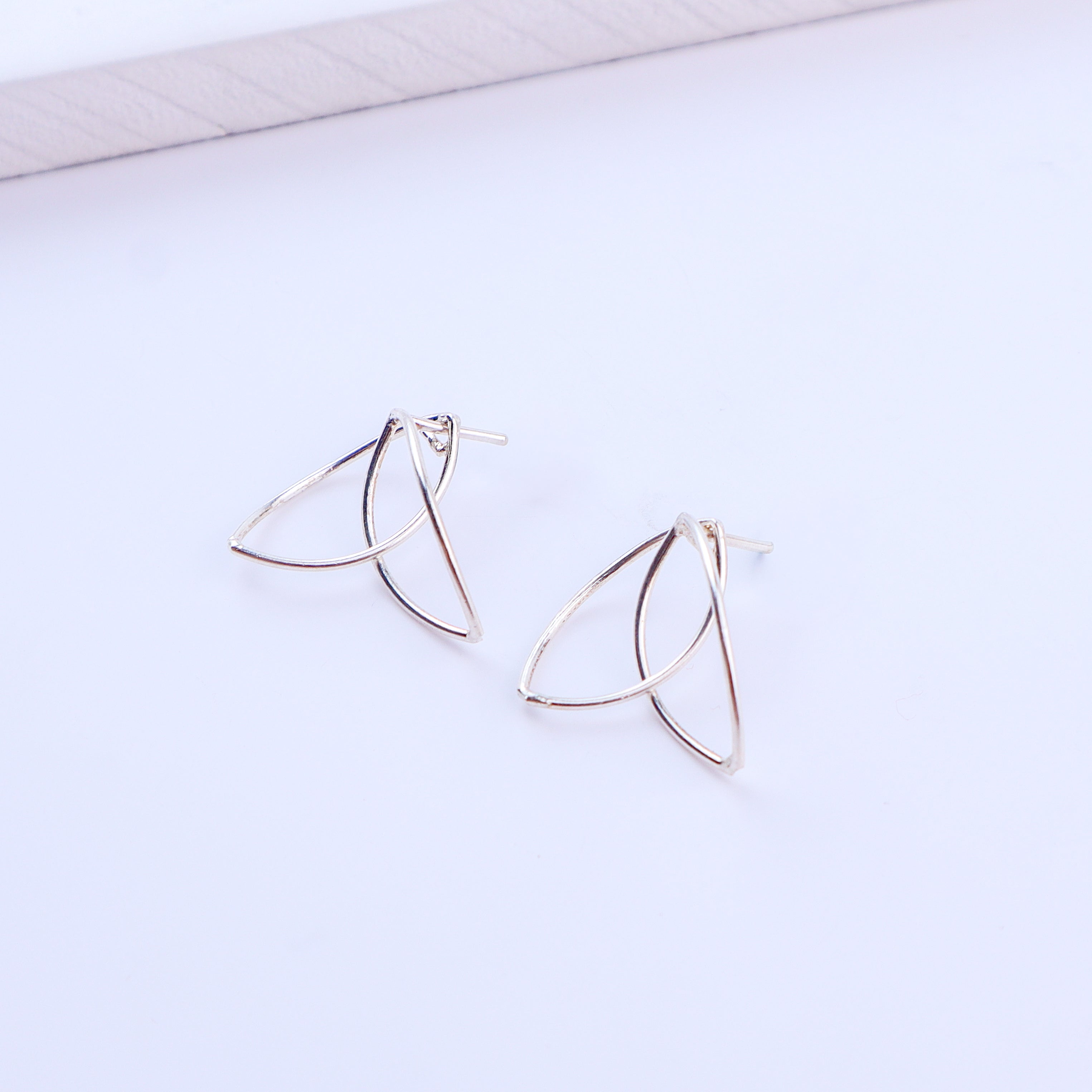 Detail shot highlighting polished silver finish and petal curves