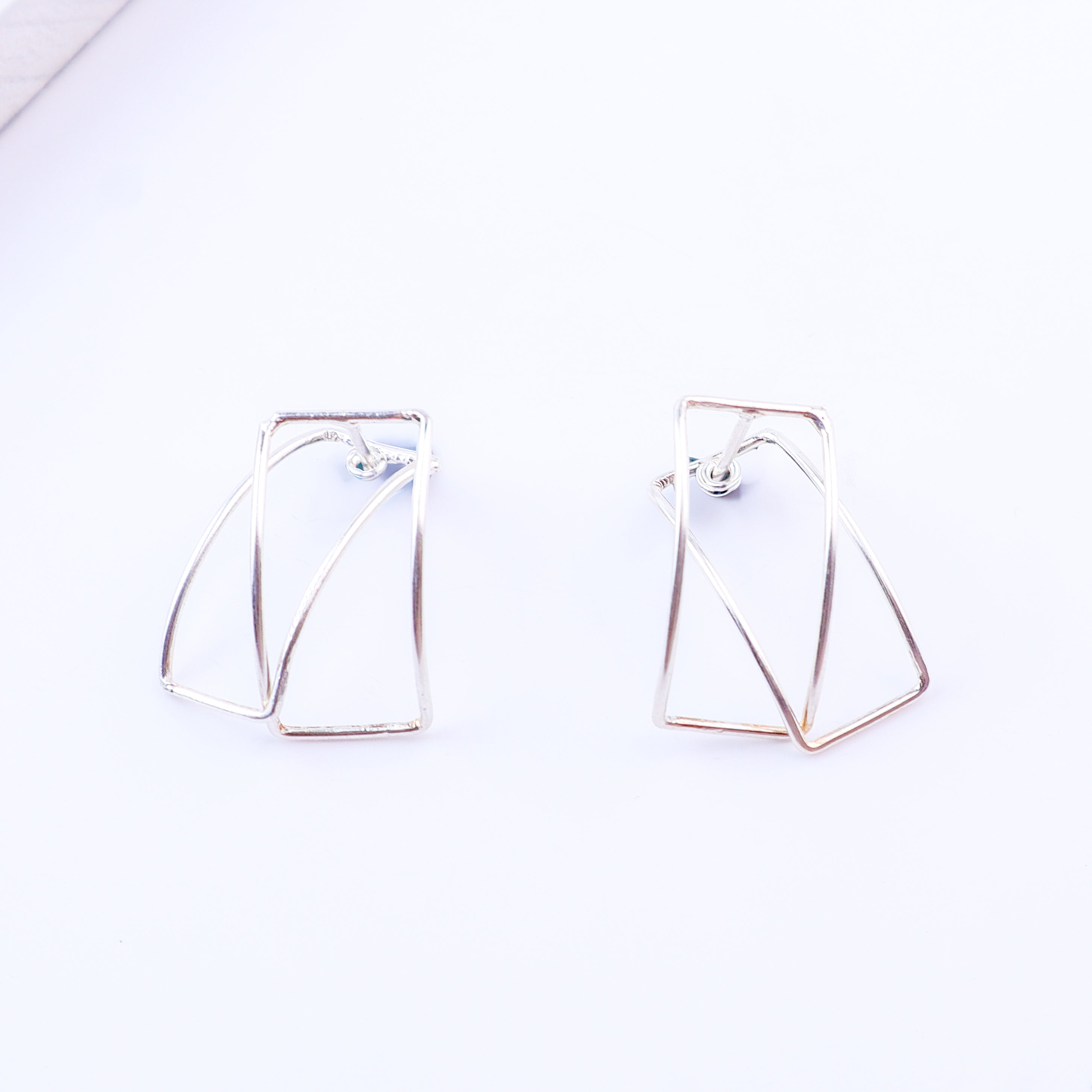 Frame arc hoops styled with modern outfit