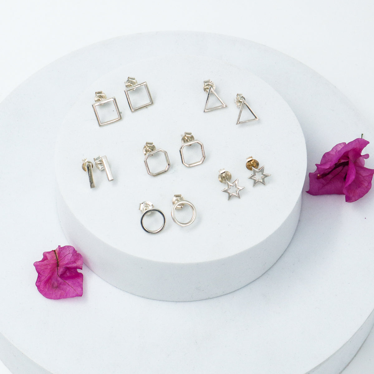 Six pair silver earrings arranged in geometry box