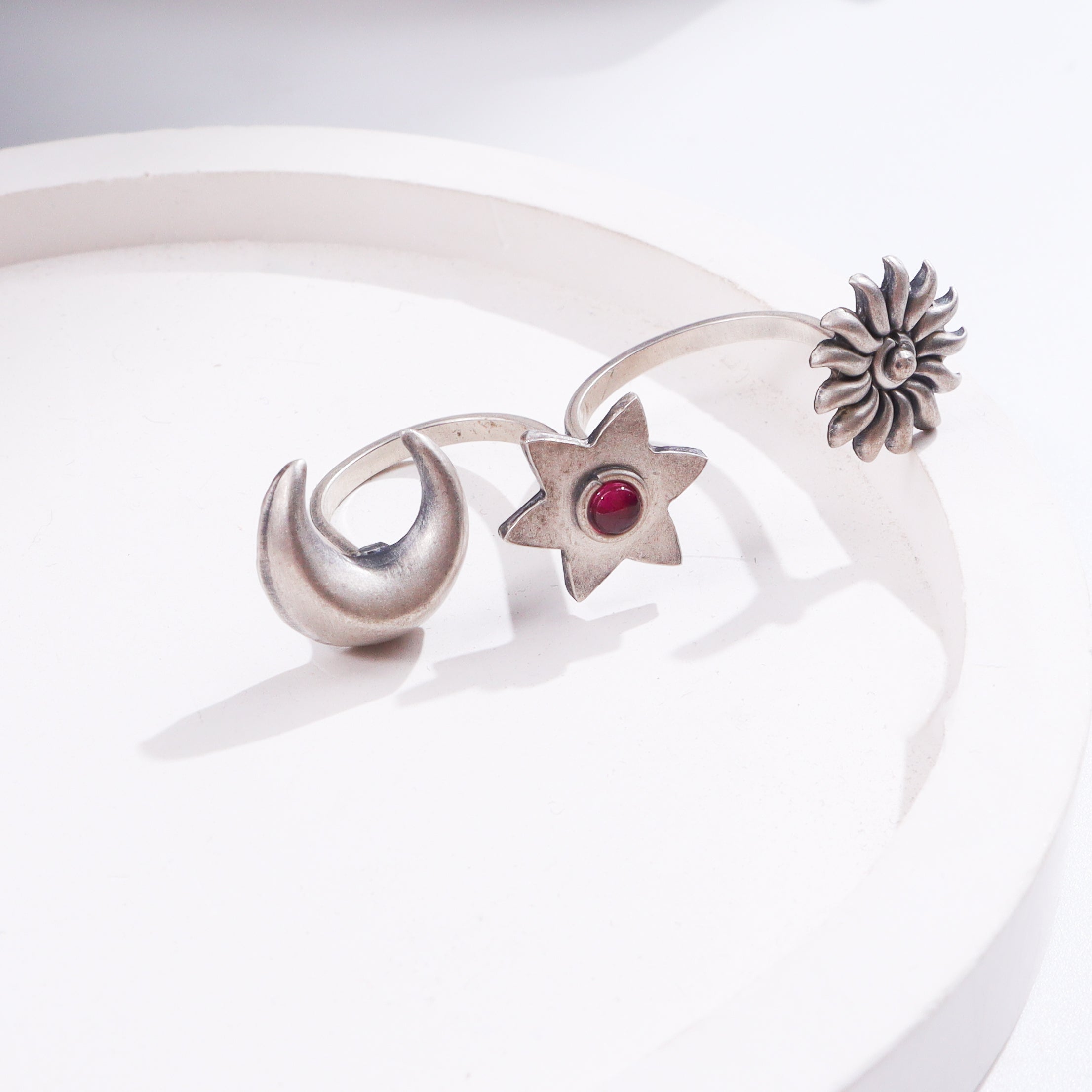 Silver flower and star jewelry with red gemstone