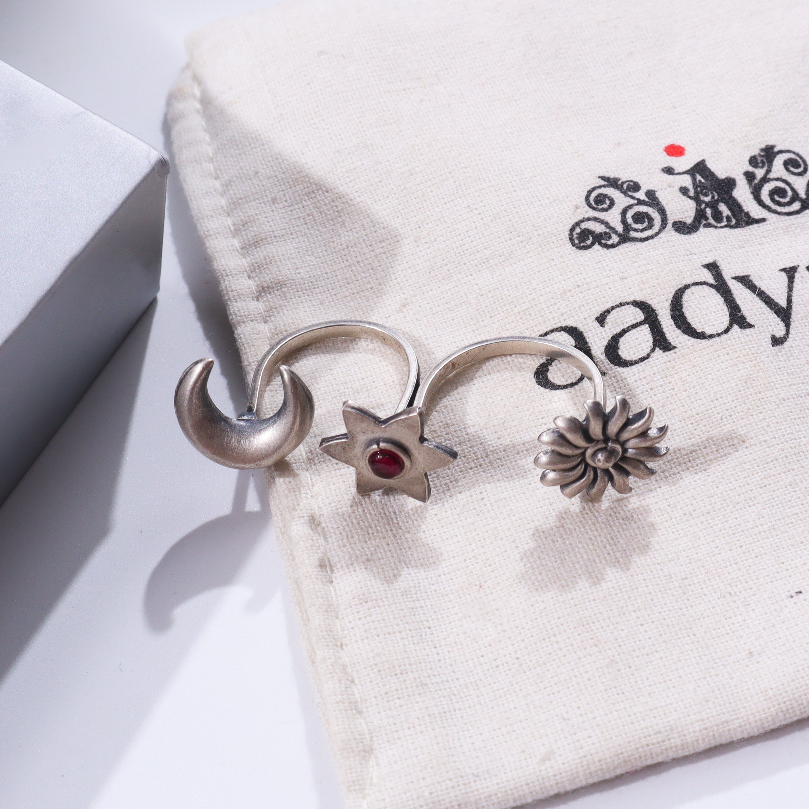 Silver rings on fabric with printed text