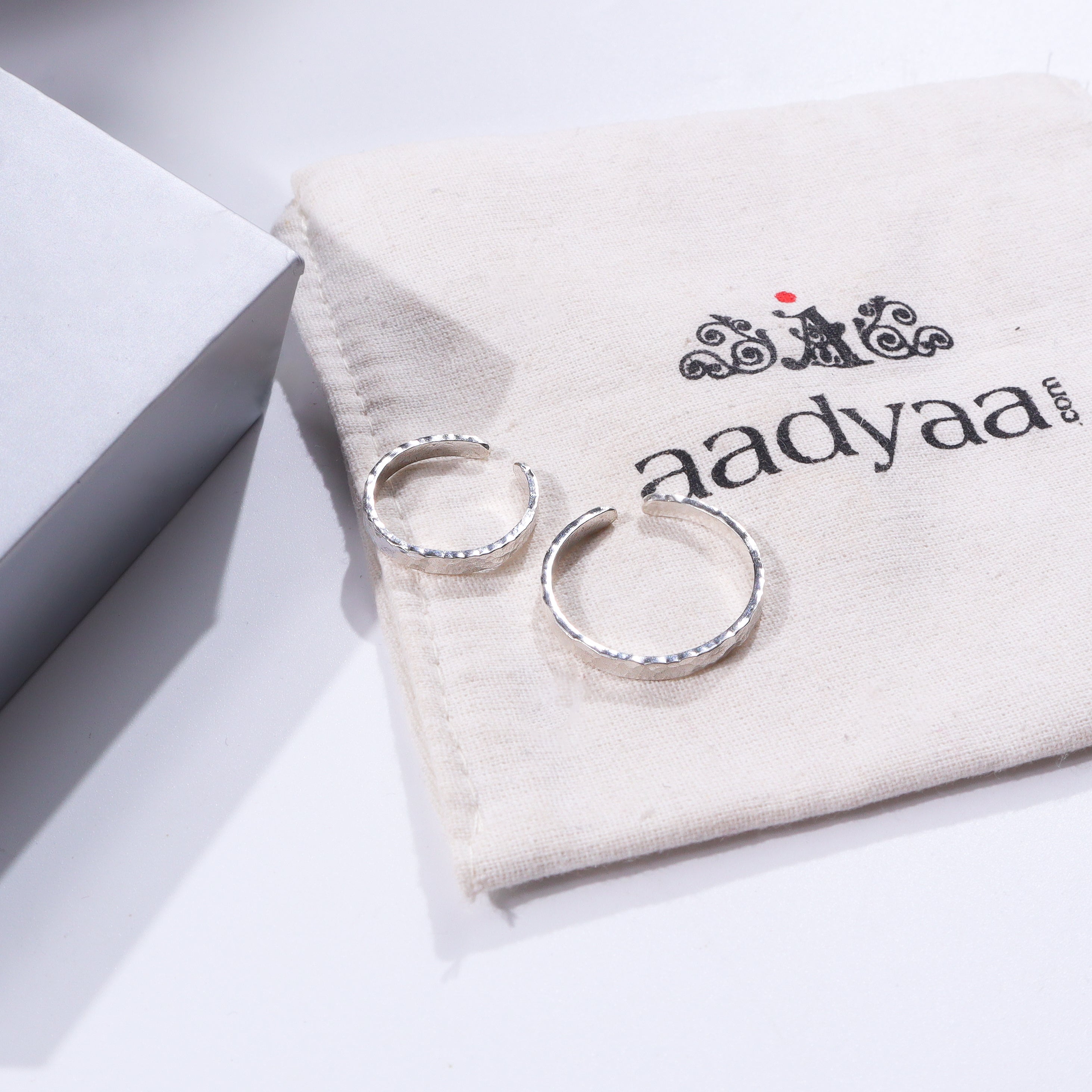 Hammered silver couple rings on fabric pouch