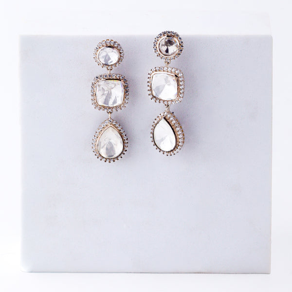 Silver earrings with large stones and intricate design, on white background
