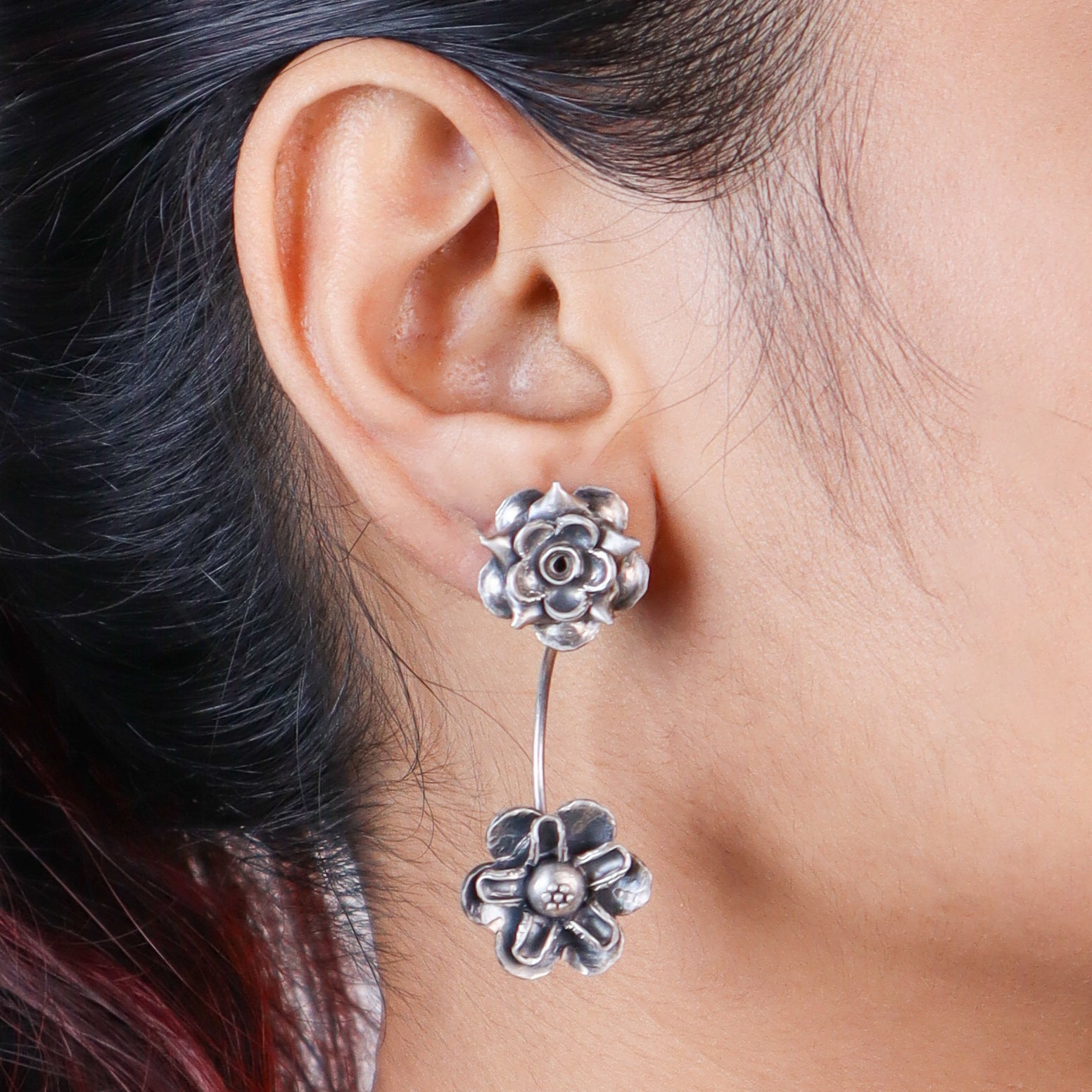 dual flower motif detailing on oxidized silver earrings