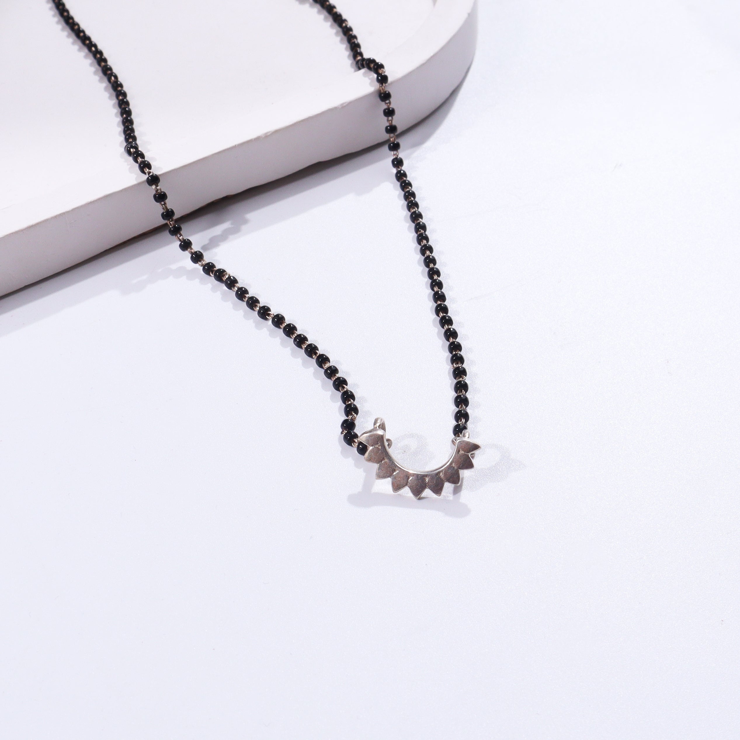 Sterling silver triangle necklace with black beads