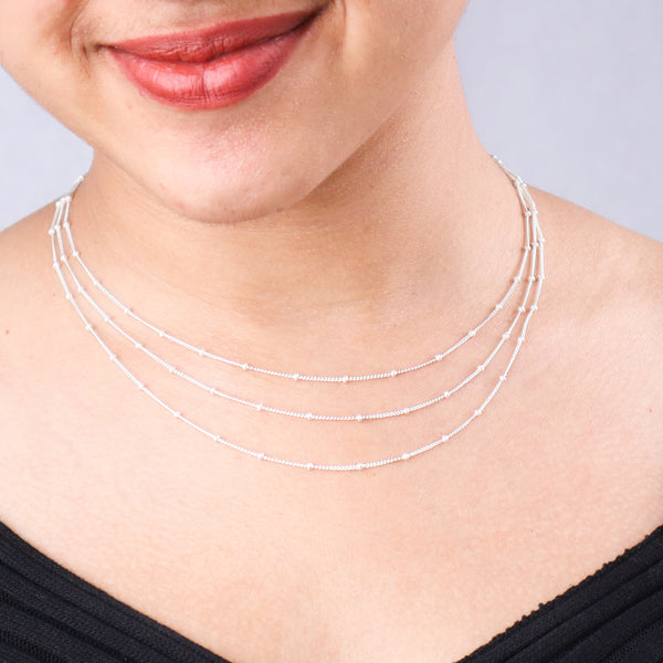 Silver layered necklace on woman