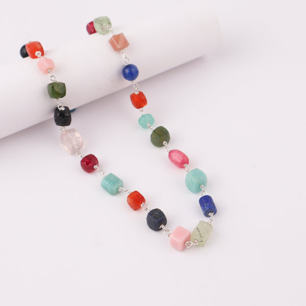 Close-up of gemstone necklace with silver chain, vibrant jewelry piece