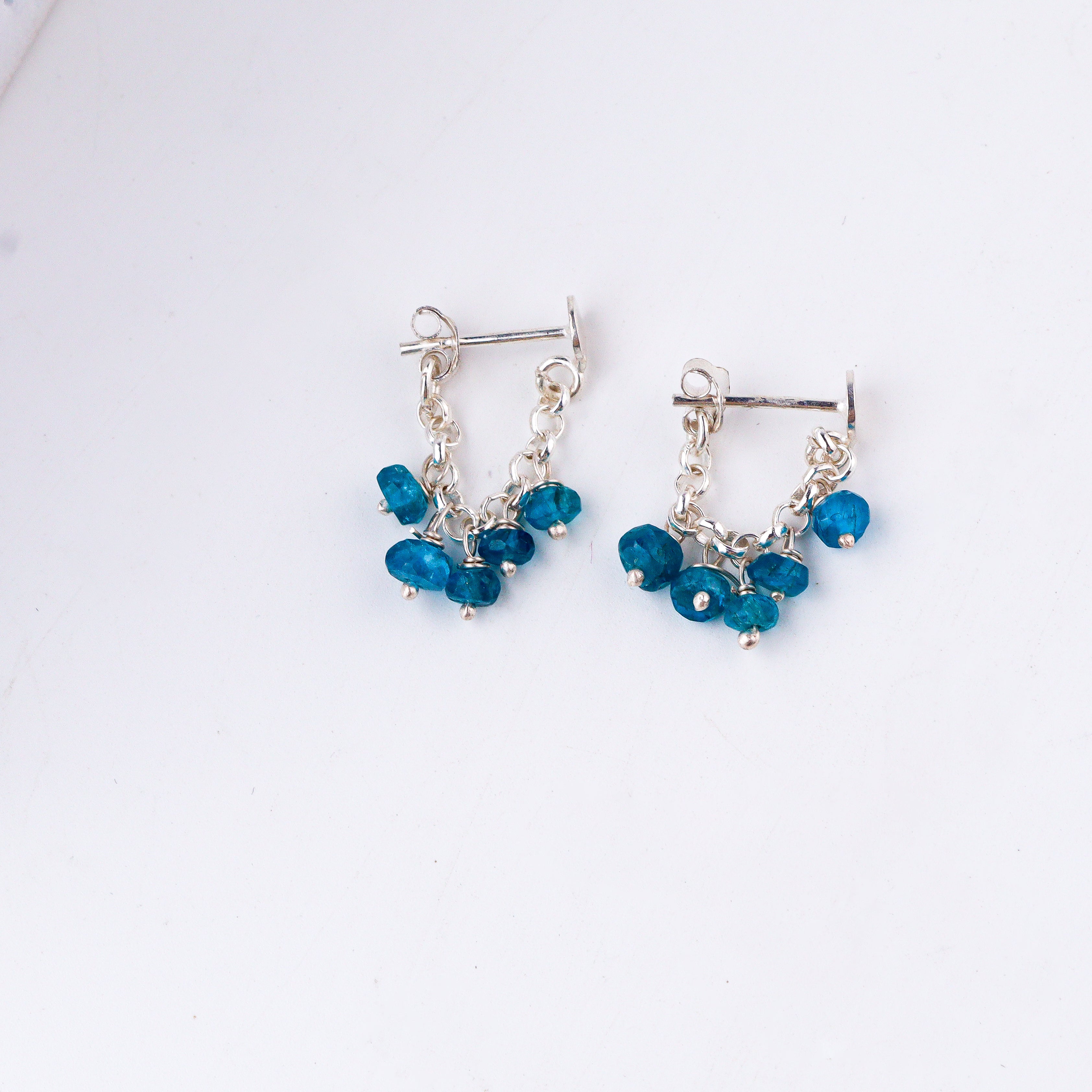 styling blue gemstone silver earrings with modern outfit