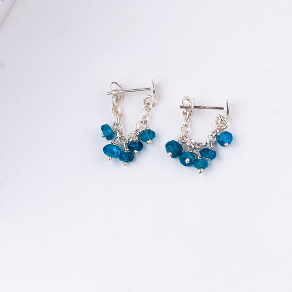 styling blue gemstone silver earrings with modern outfit