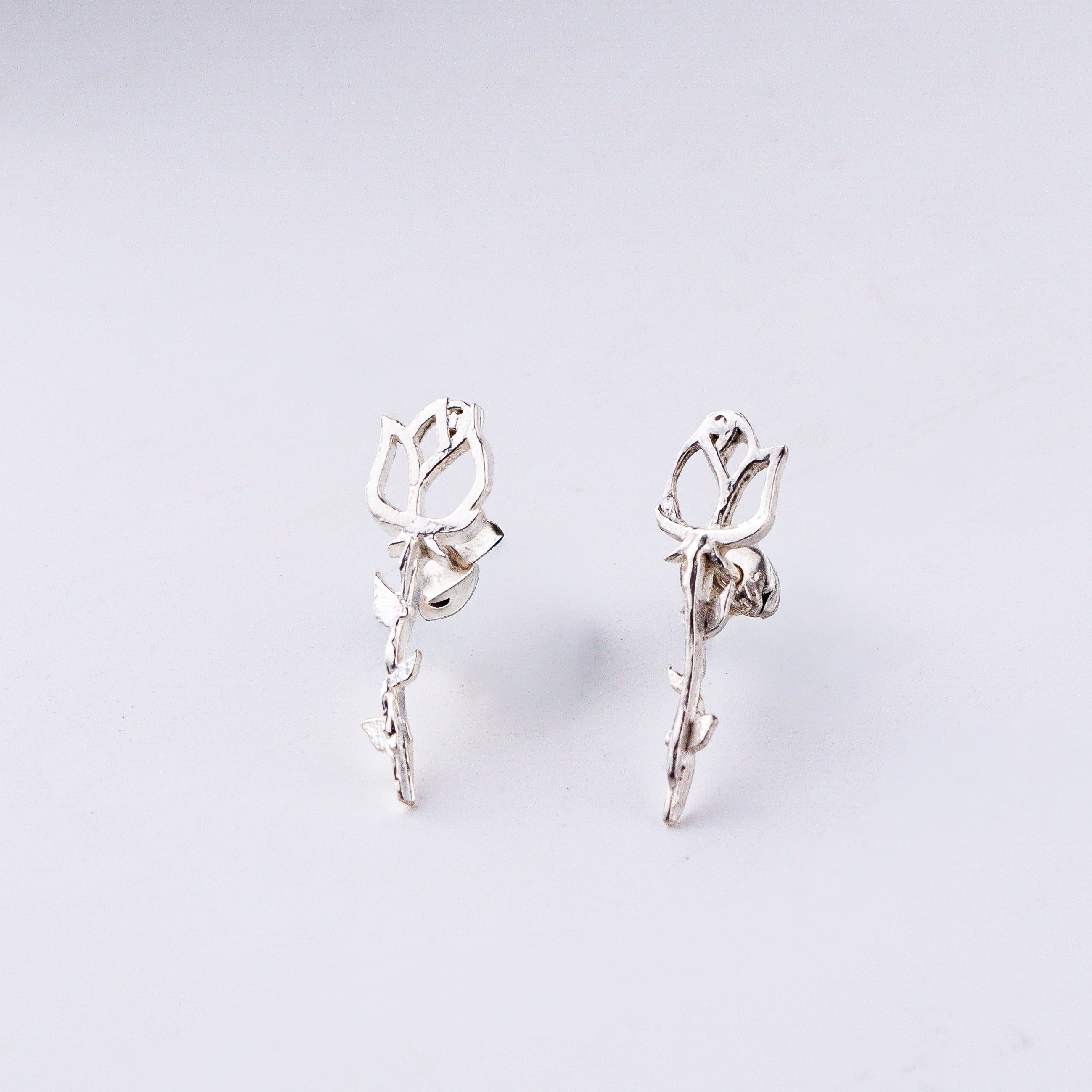 Handcrafted rose motif silver earrings polished finish