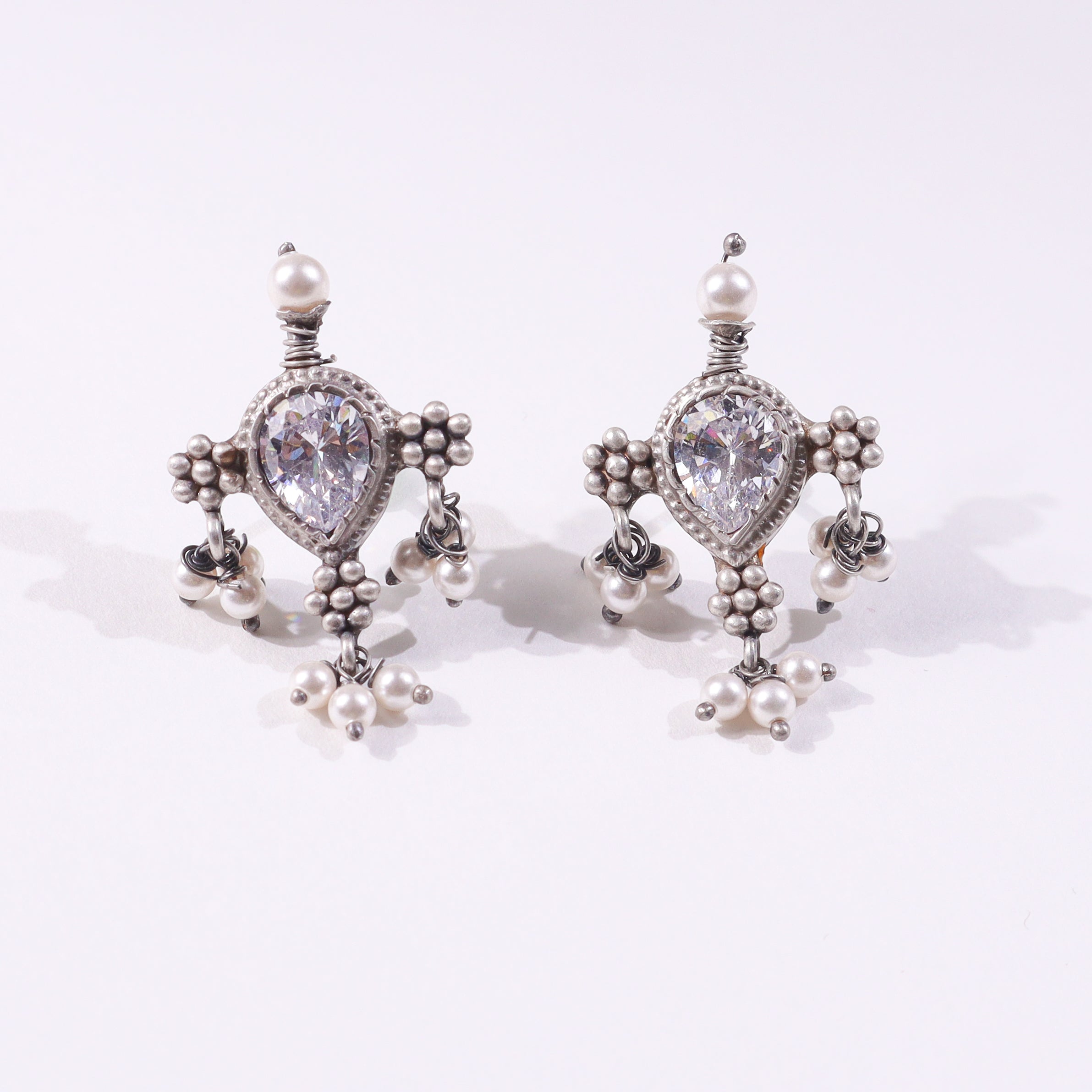Silver earrings with pearl accents and crystal center