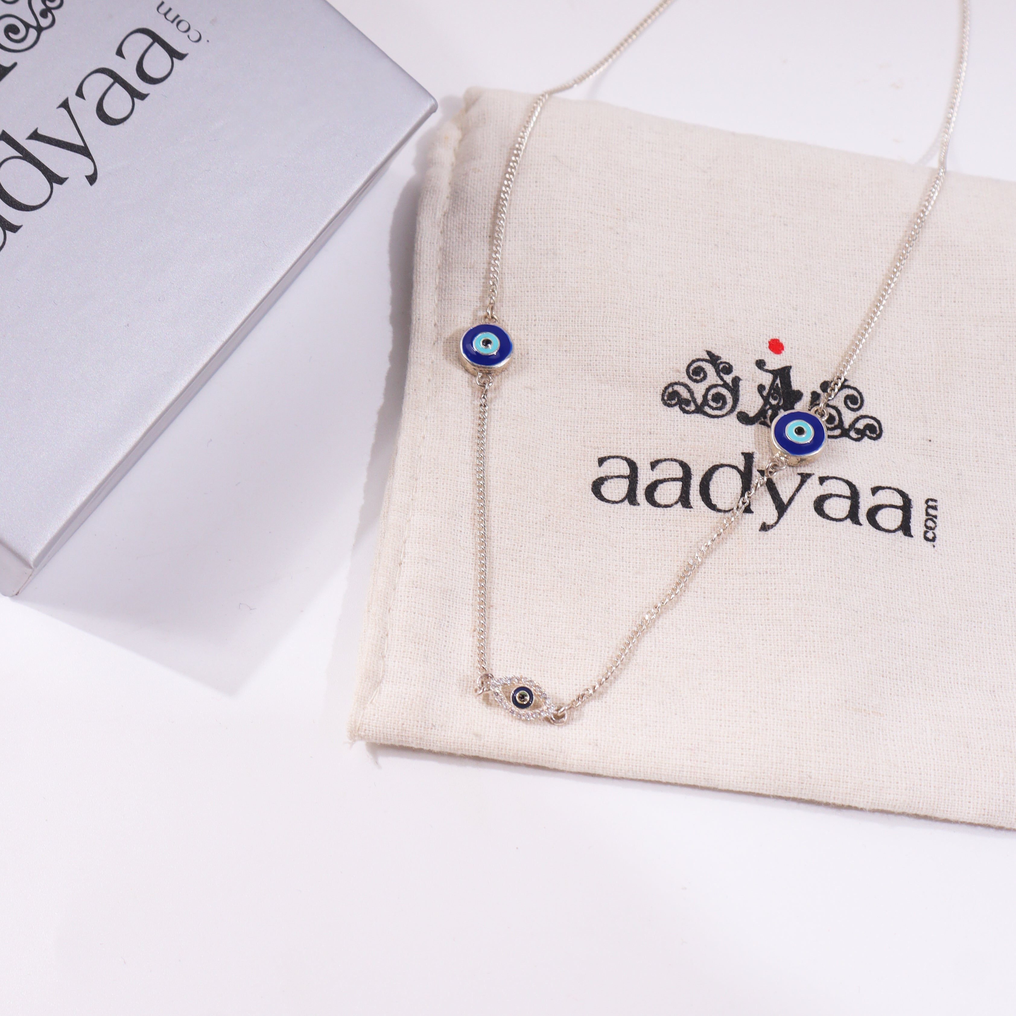 Evil Eye Necklace in sterling silver with blue eye charm on jewelry display