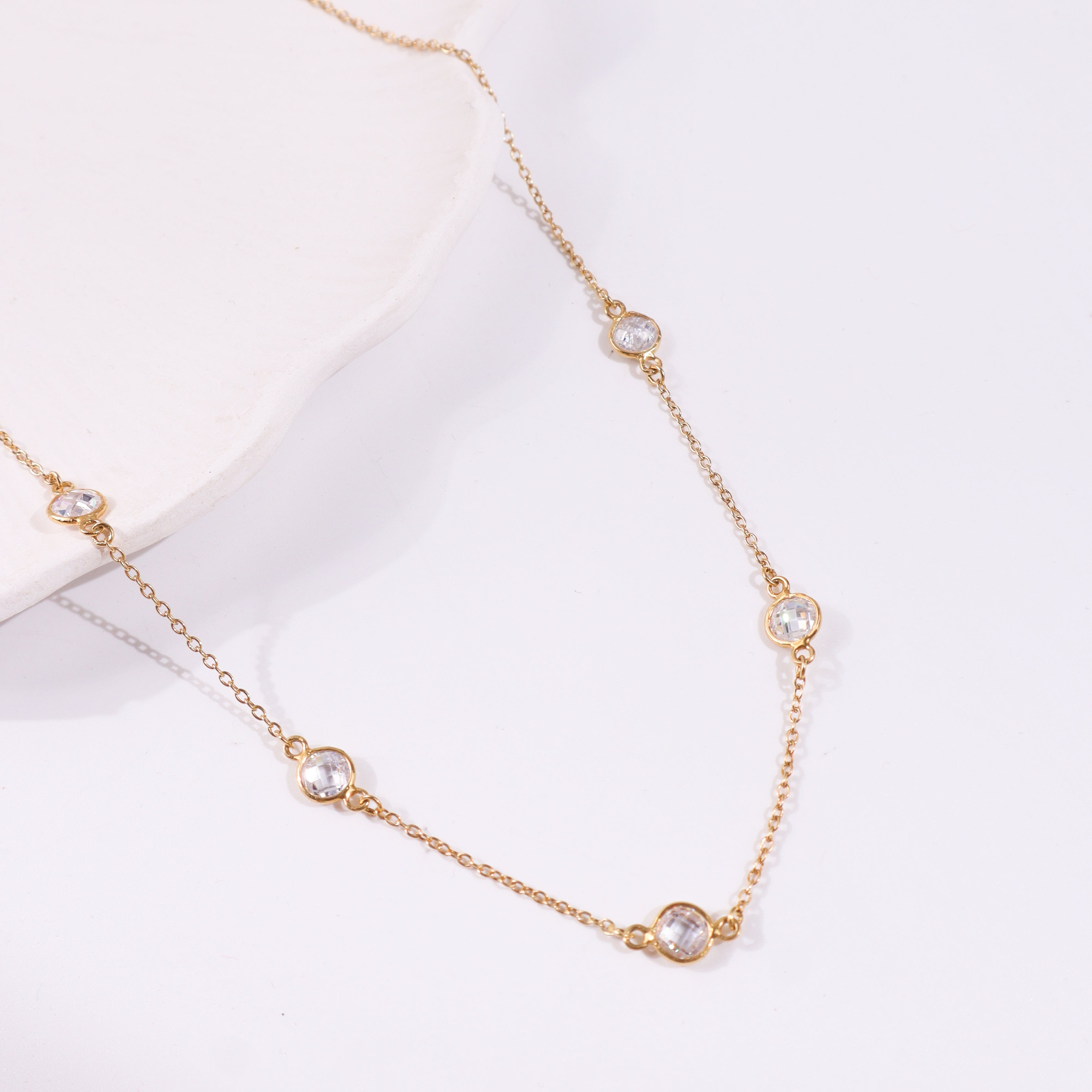 Gold chain necklace with clear gemstone accents