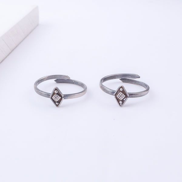 Model wearing tiny silver adjustable textured diamond toe ring