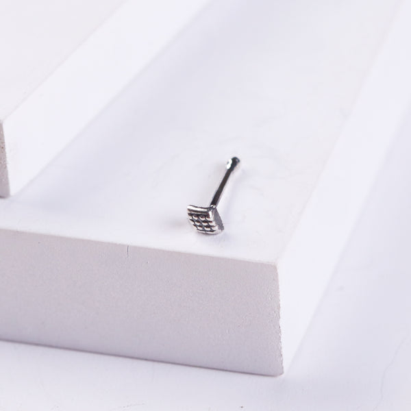 Silver dotted diamond nose pin on white background