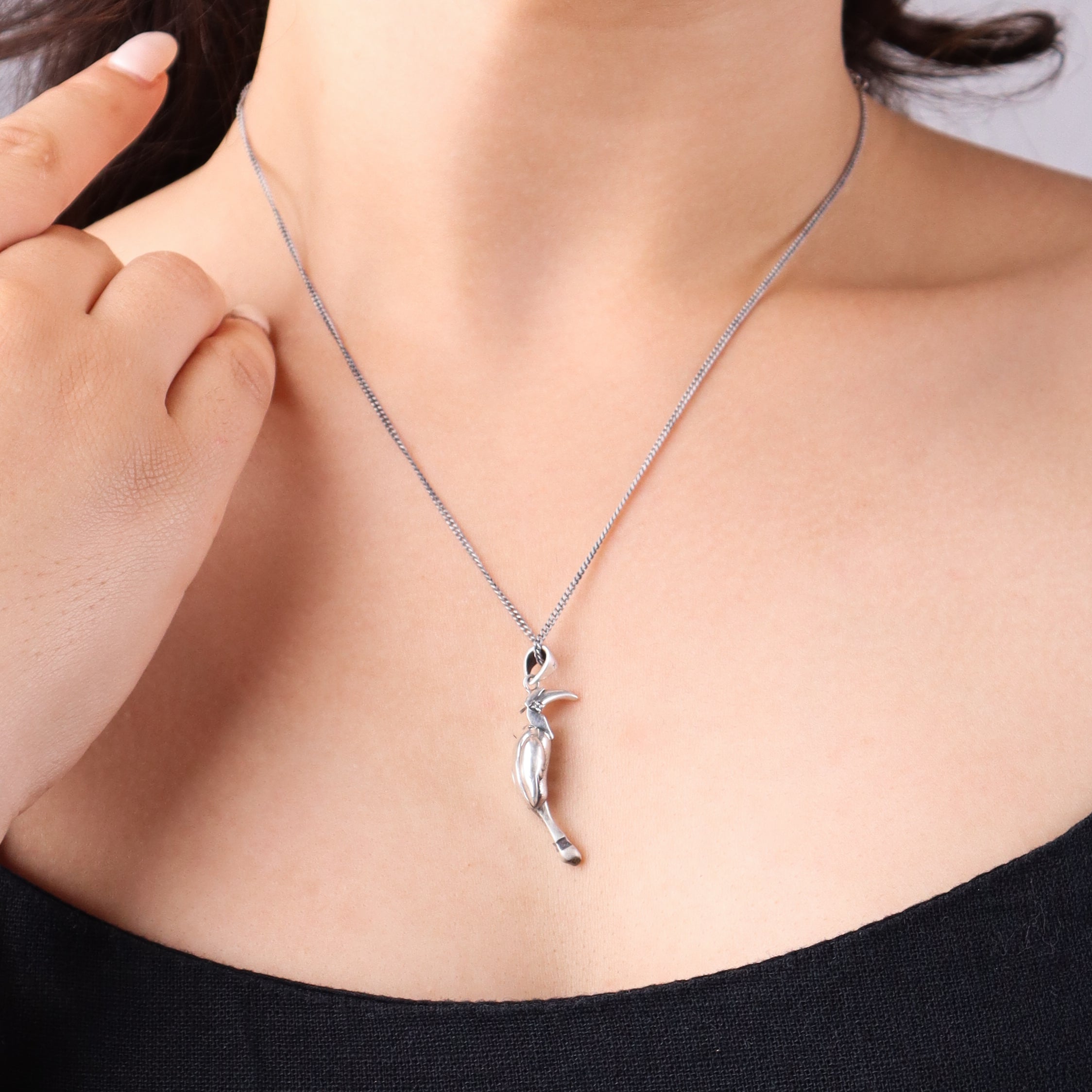 Silver Hornbill pendant on neck