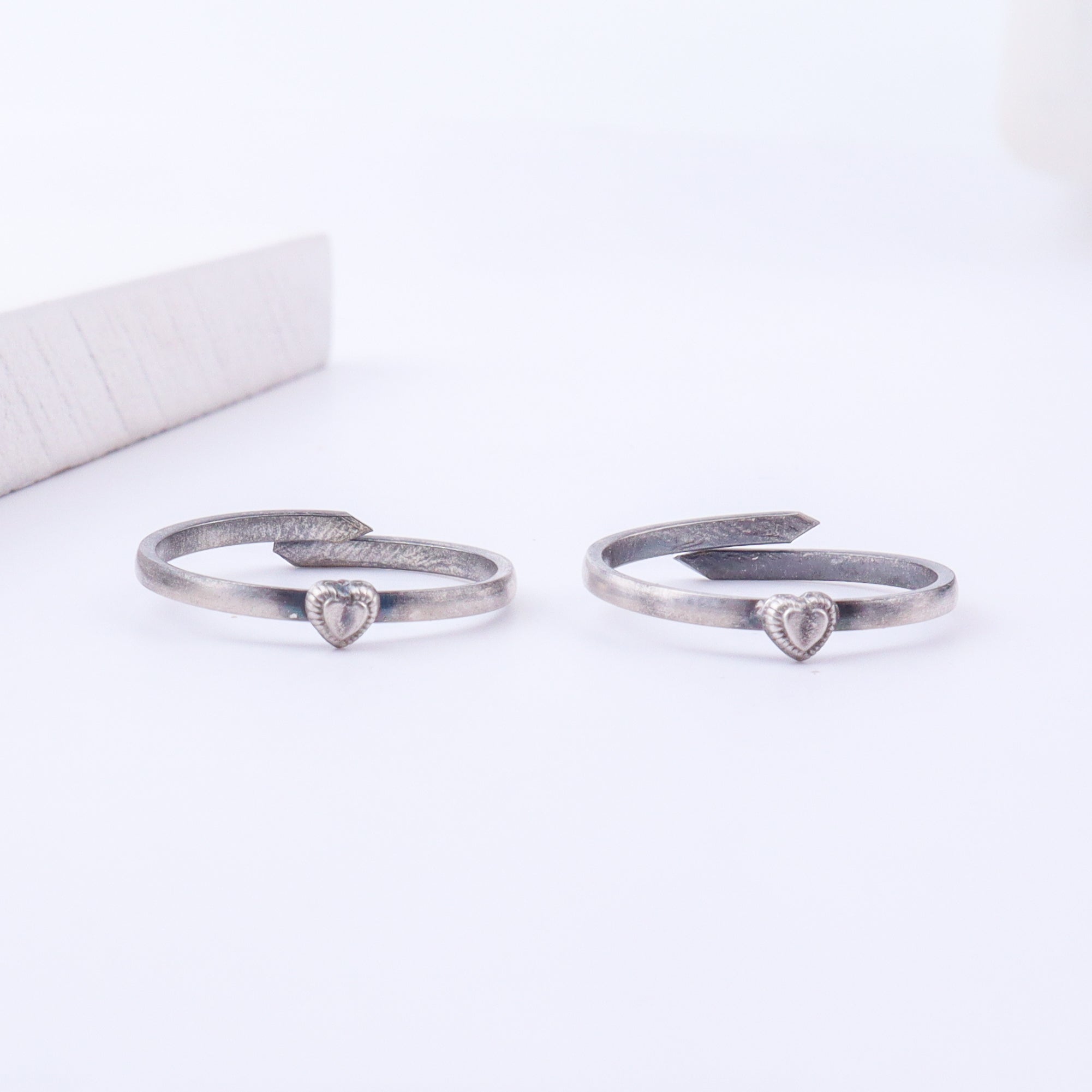 Model wearing tiny silver adjustable heart toe ring