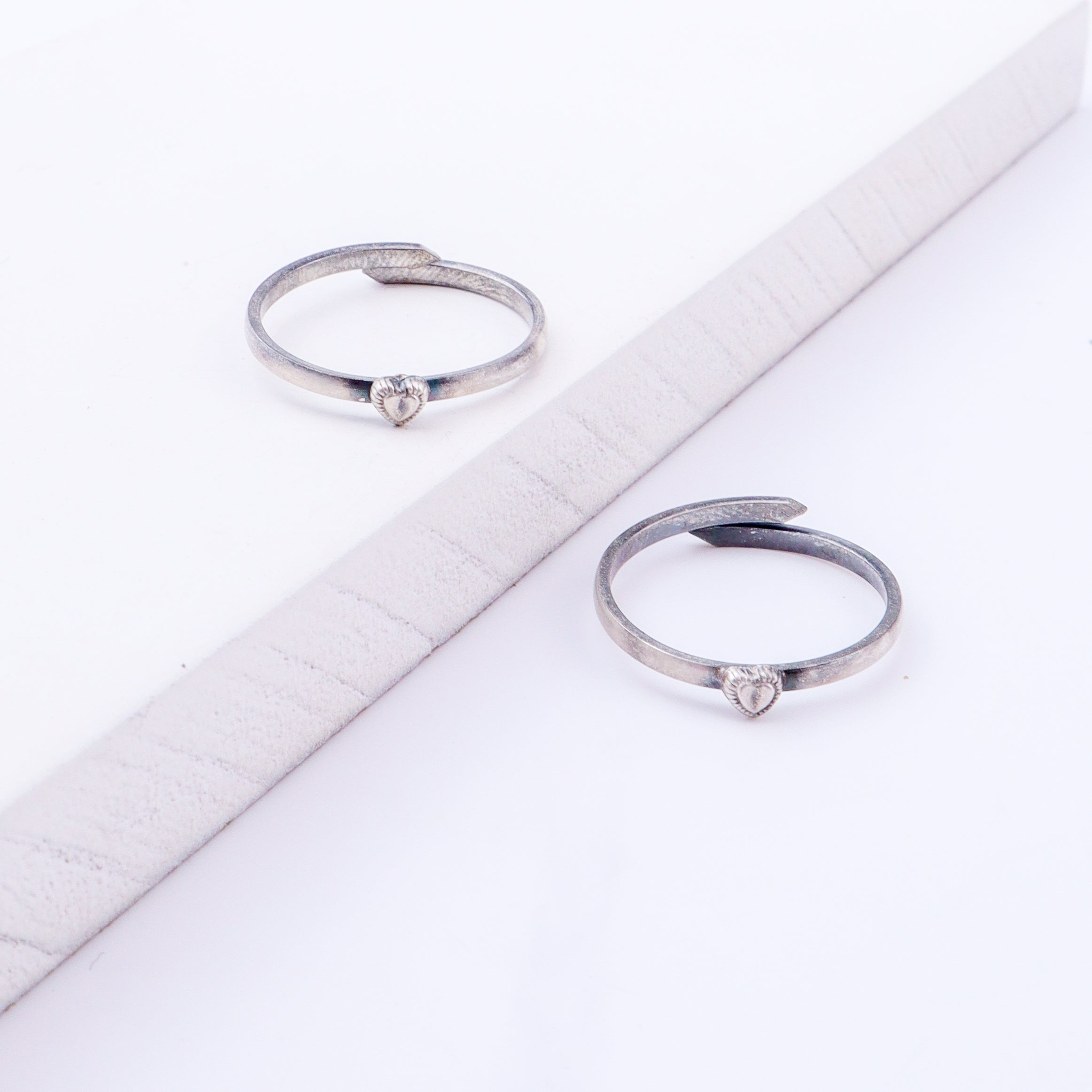 Angled view of tiny silver heart adjustable toe ring