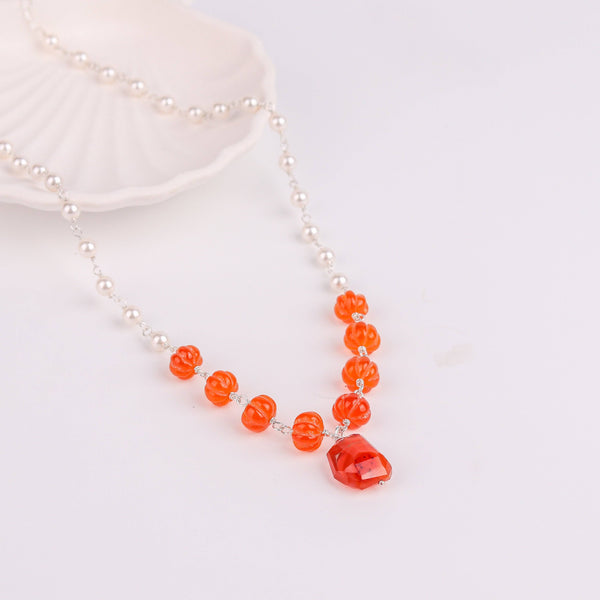 Angled side view of 92.5 silver pearl Ganthan necklace showing layered pearls and gemstone arrangement