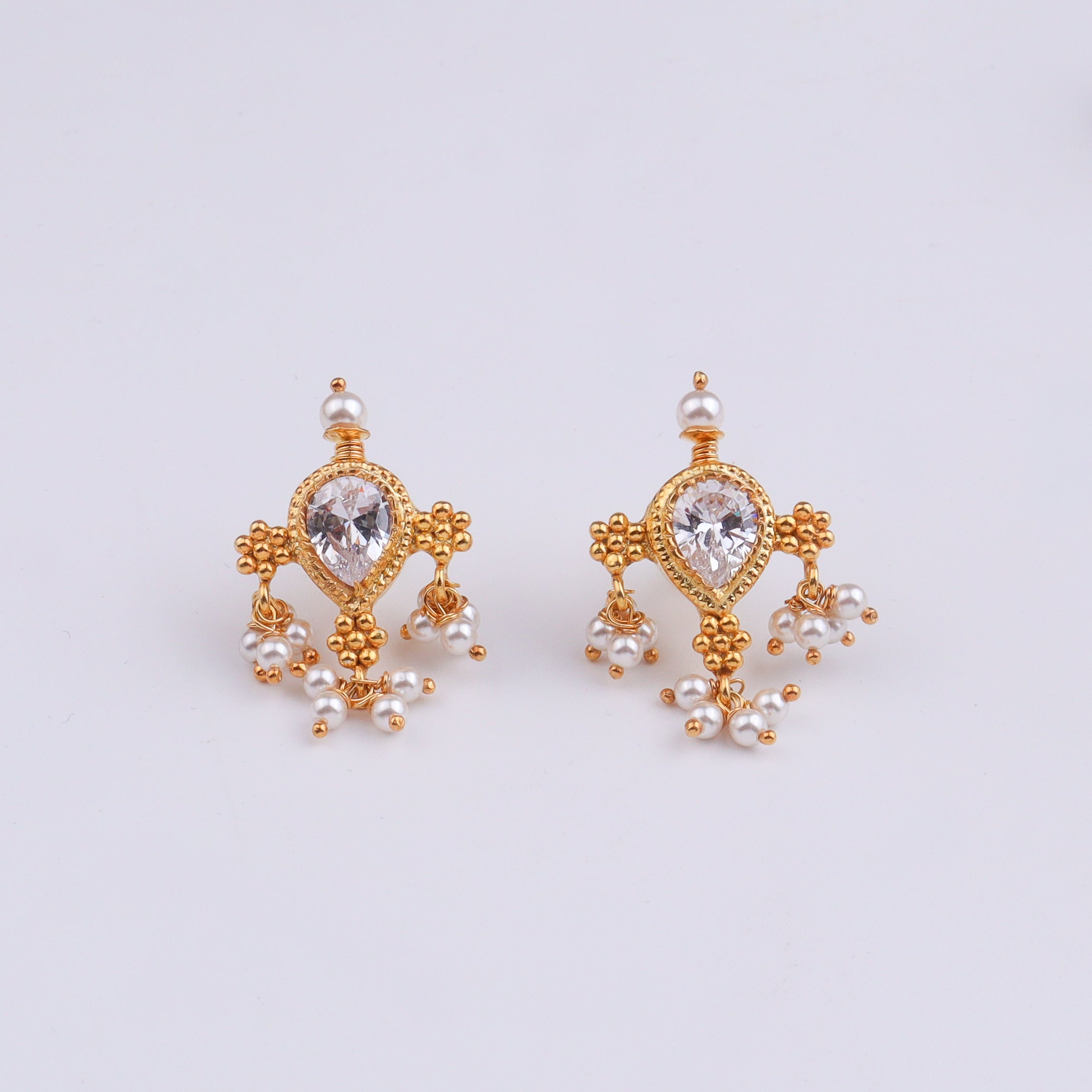 Gold and pearl earrings with intricate design