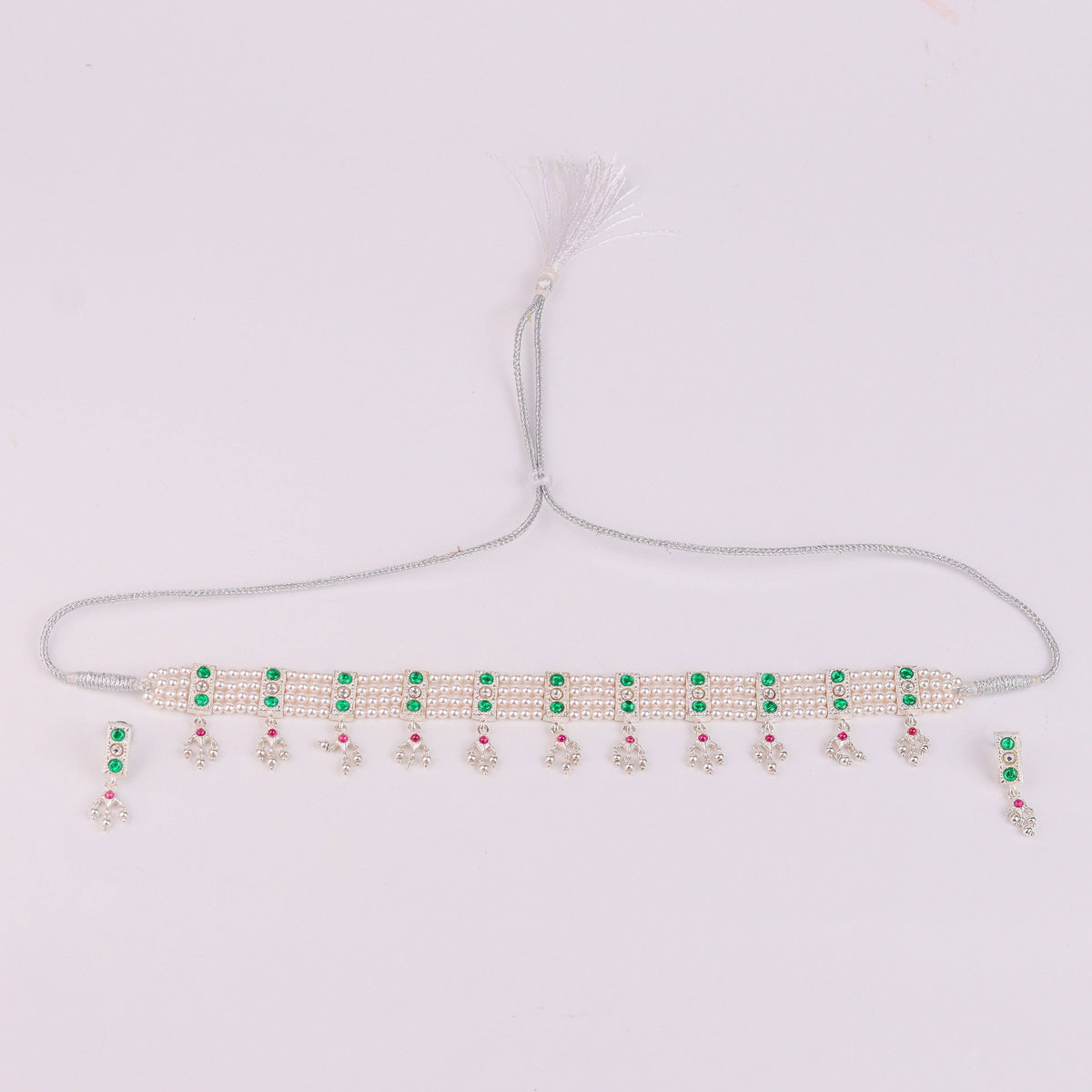 Flat lay of Silver Green Stone and Pearls Chinchapeti Set