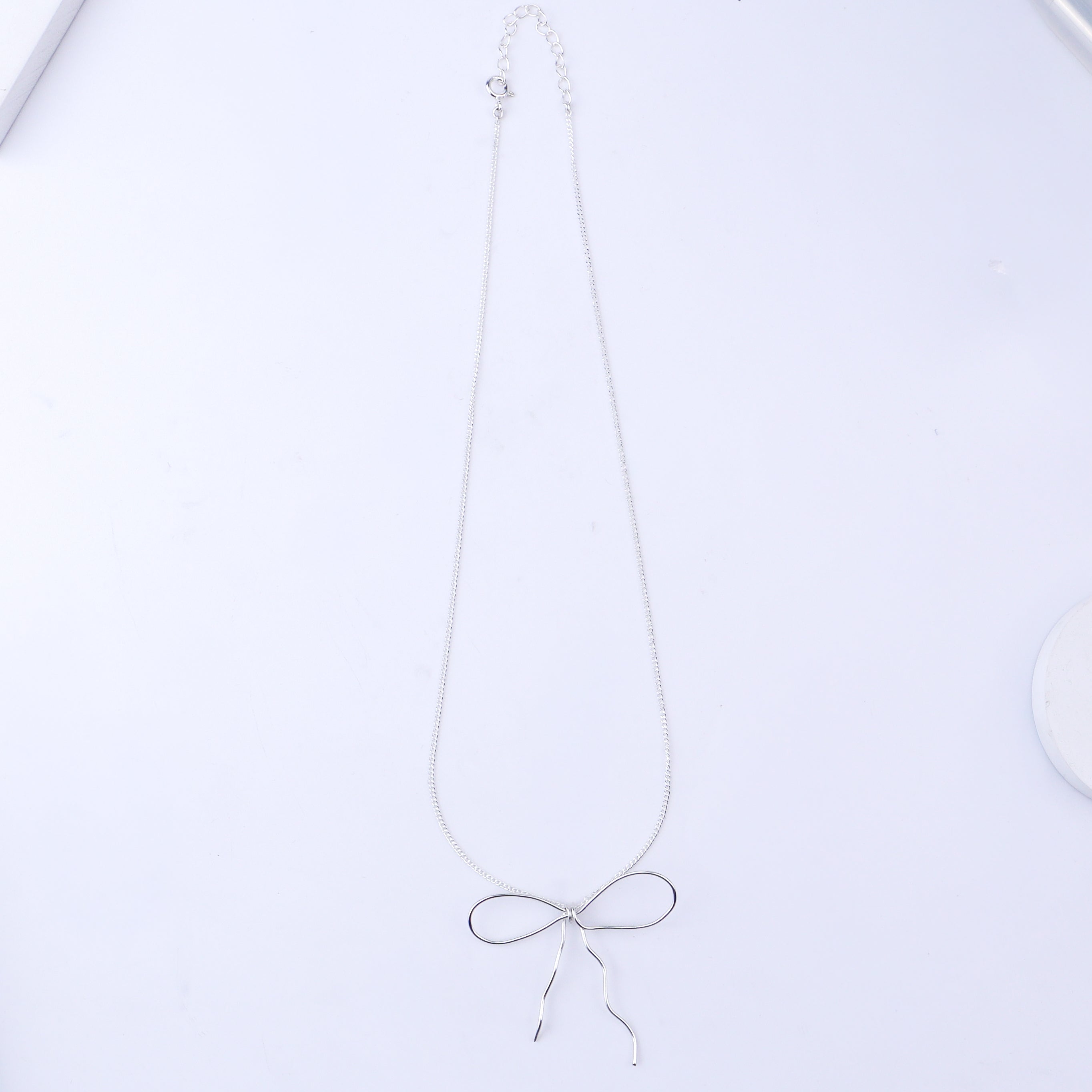 Silver bow necklace with chain and pendant