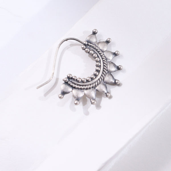 Silver star-shaped jewelry piece with beaded design