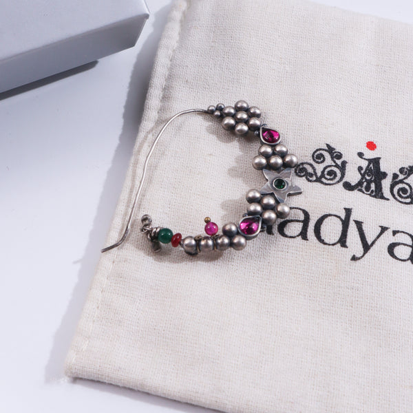 Silver Indrayani Nath with pink gemstone on beige fabric