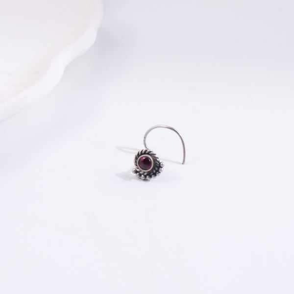 Silver crescent nose pin with purple gemstone