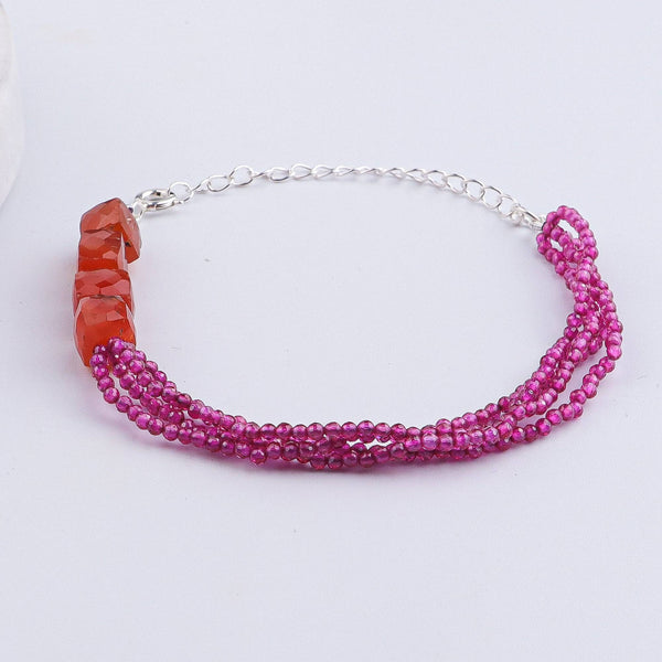 Flat-lay of Carnelian & Ruby Silver Bracelet with natural stones and handcrafted silver jewellery styling