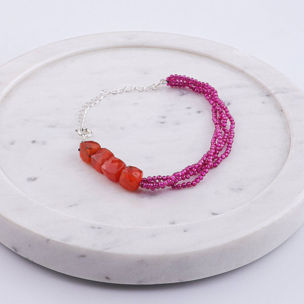 Angled view of Carnelian & Ruby Silver Bracelet in 92.5 sterling silver with carnelian and ruby stone detailing