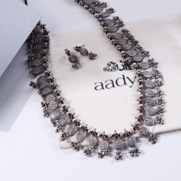 Silver oxidized necklace with coin motifs and red stones