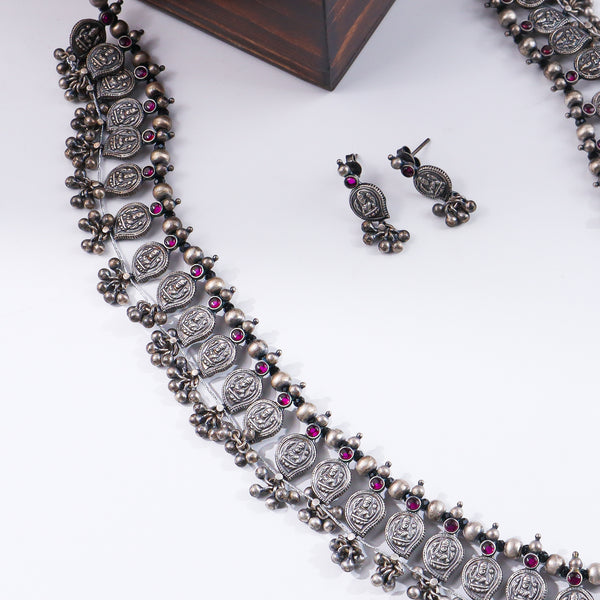 Silver oxidized necklace with traditional coin motifs and pink gemstones