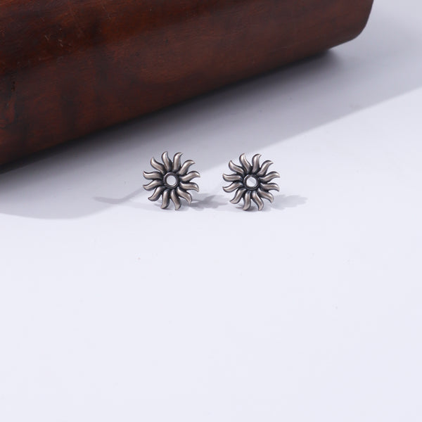Silver Sun Motif Studs earrings with floral design on white background