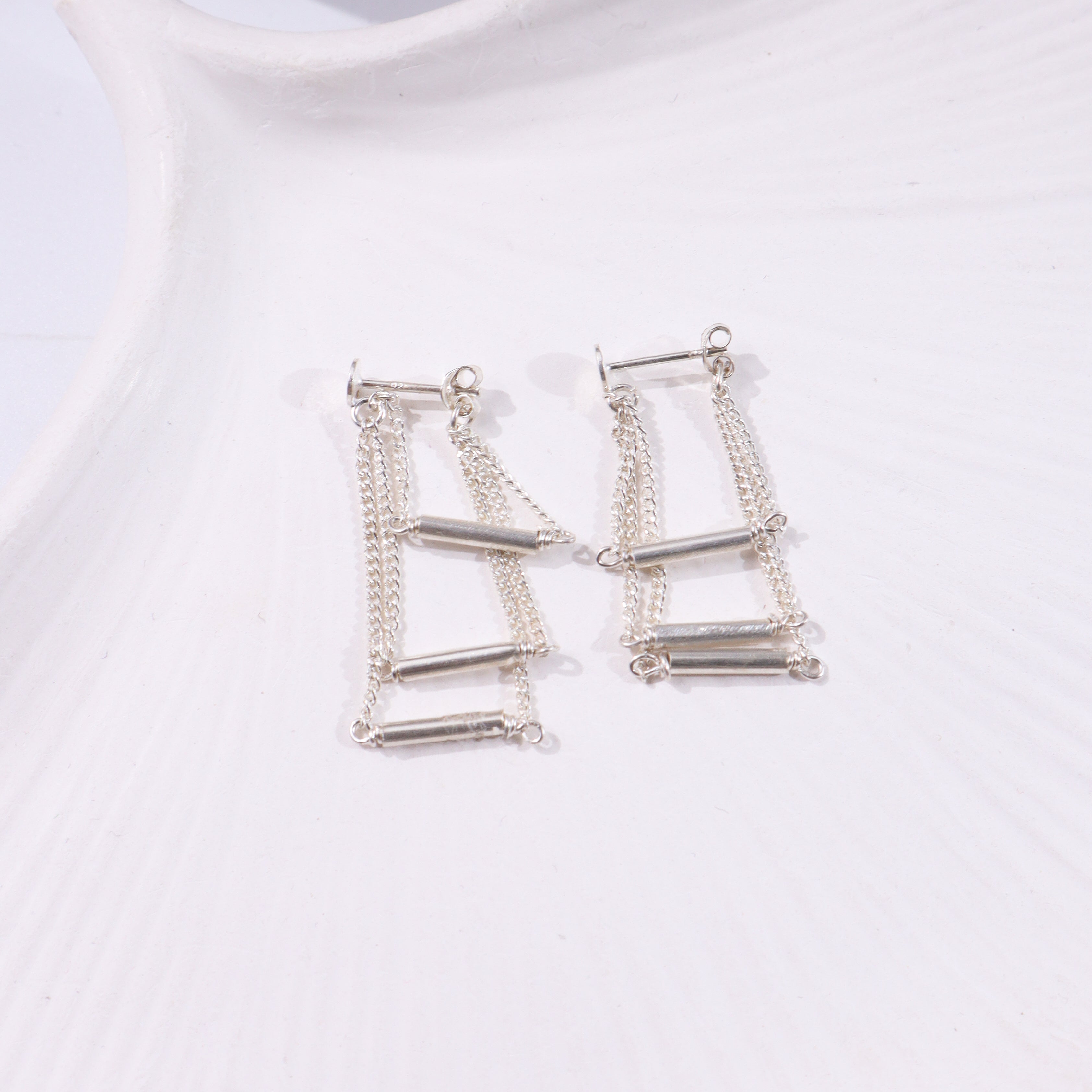 Silver layered chain earrings with cylindrical bars and dangling chains