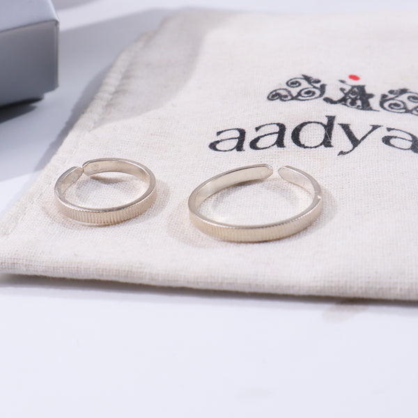 Textured silver couple rings on fabric