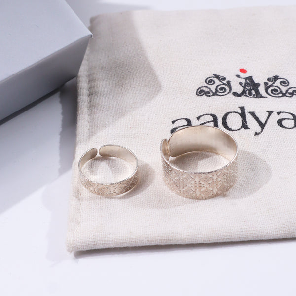 Textured couple rings on fabric with decorative logo