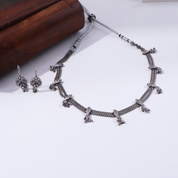 Silver jewelry set with intricate peacock motifs