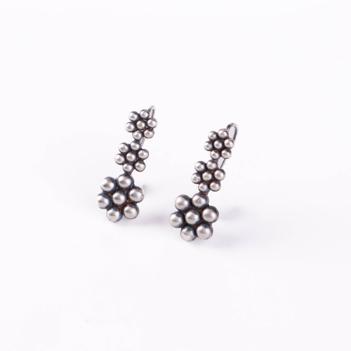 Detail shot of Kudi motif and polished silver finish