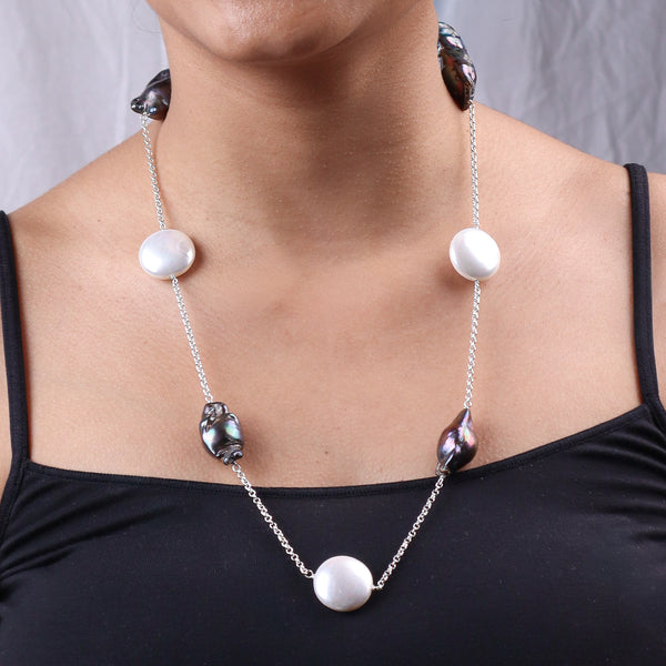Model wearing silver necklace with baroque pearls