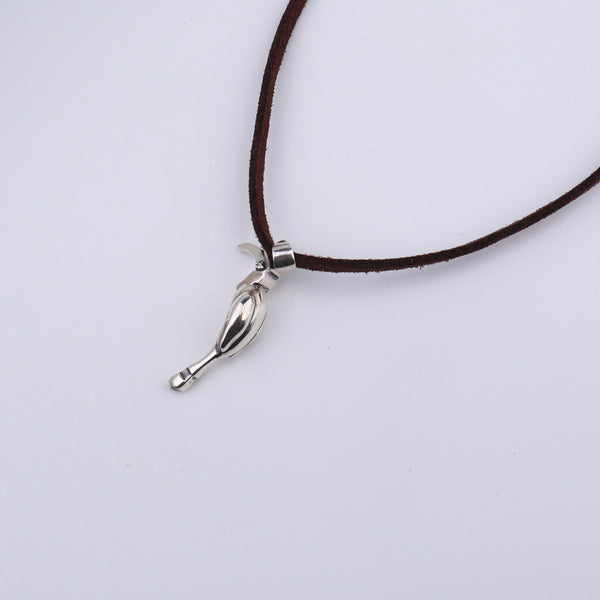 Close-up of Silver Hornbill pendant on brown suede cord