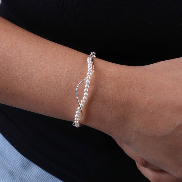 Pearl bracelet on wrist with silver chain