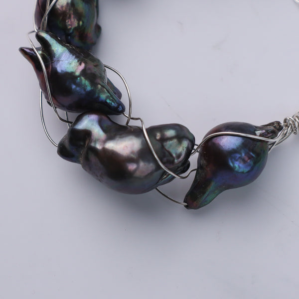 Bracelet on wrist showing black baroque pearls and silver chain, House of Aadyaa jewelry
