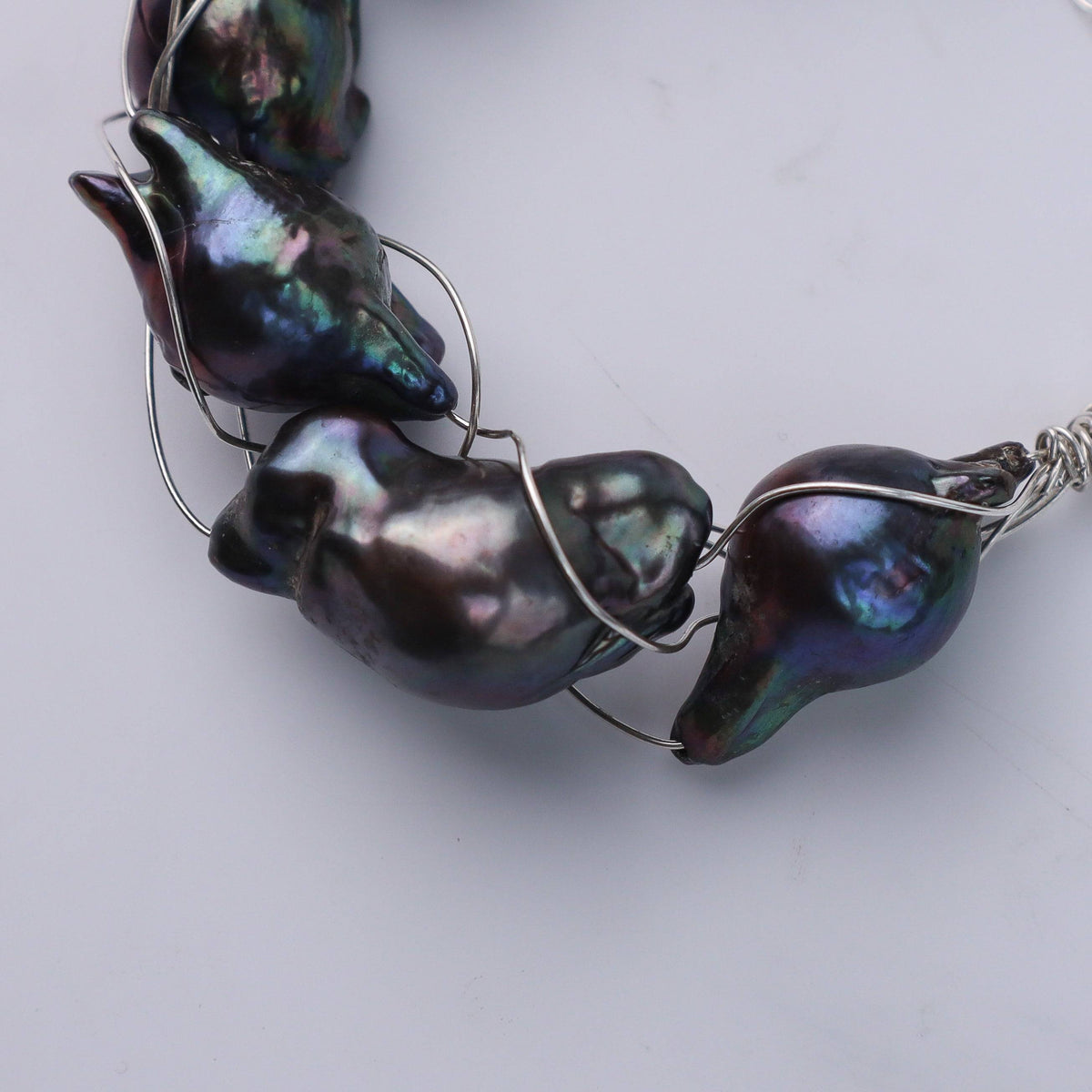 Bracelet on wrist showing black baroque pearls and silver chain, House of Aadyaa jewelry
