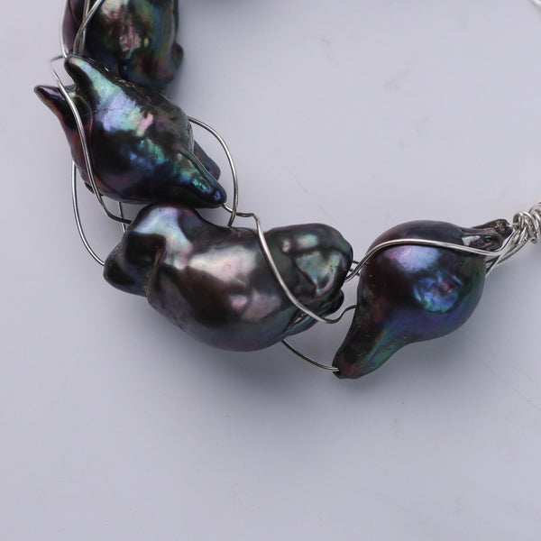 Bracelet on wrist showing black baroque pearls and silver chain, House of Aadyaa jewelry