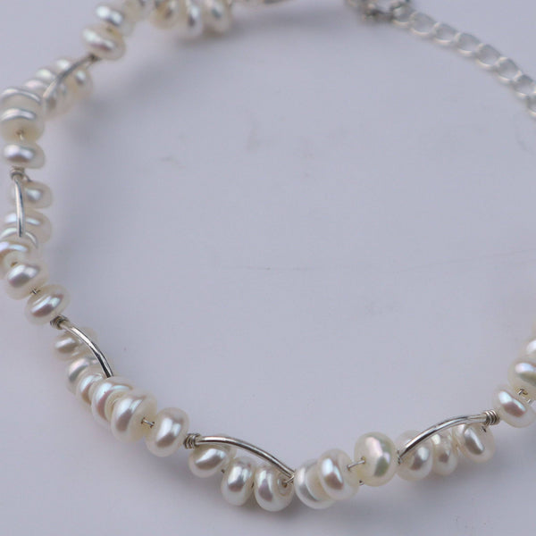 Pearl twisted bracelet with silver chain detail