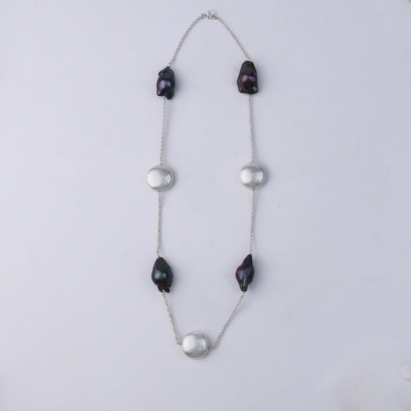 Close-up of black pearl pendant on silver chain