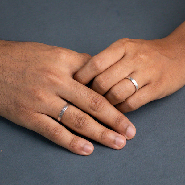 Hammered couple rings in silver on hands