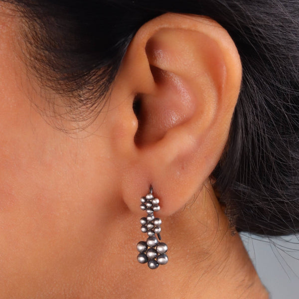 Close-up of Kudi Dangling Earring with intricate silver detailing