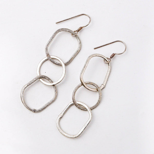 Angled view of the fashion earring highlighting its unique silhouette, structure, and polished finish